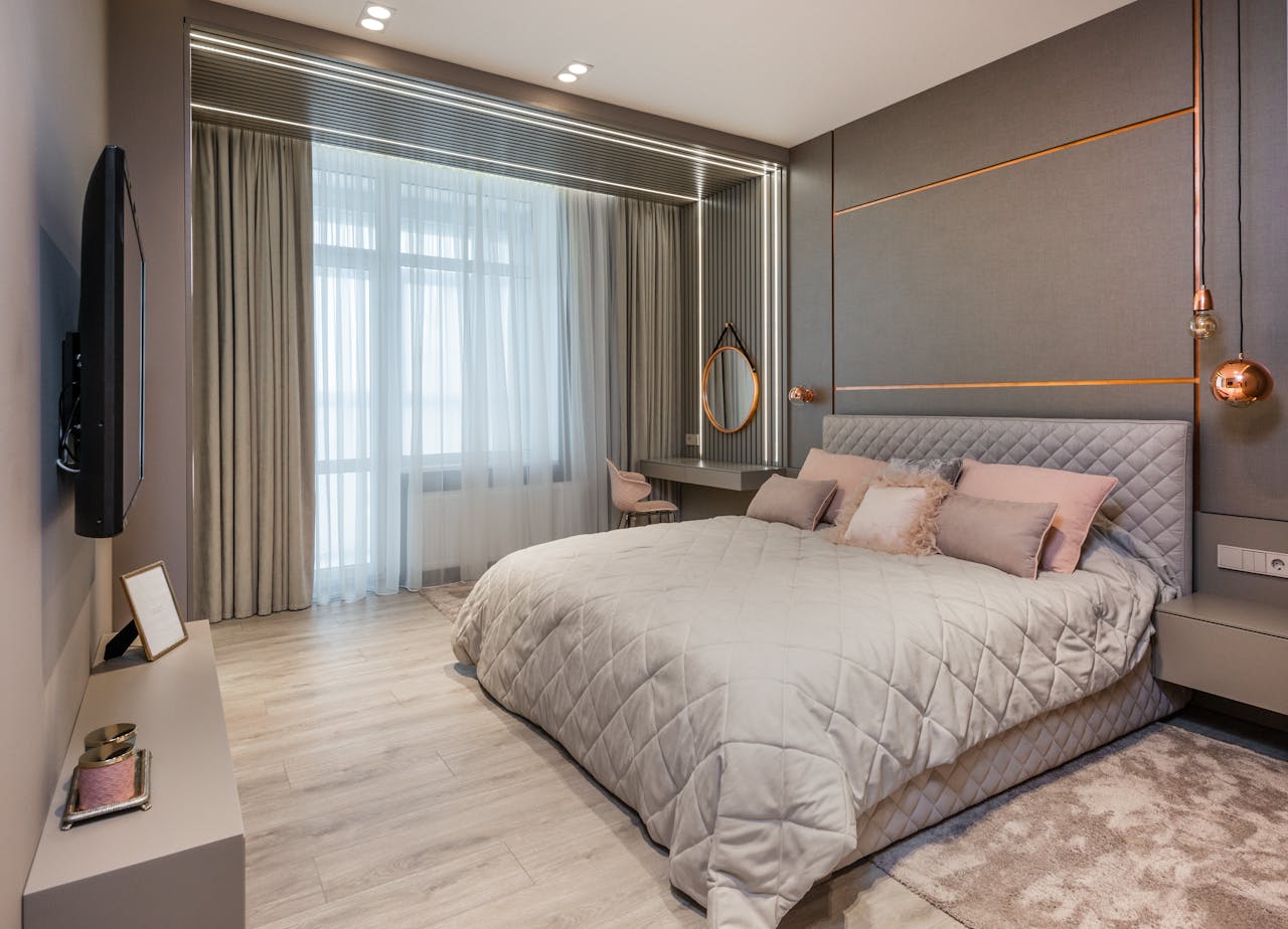 Elegant bedroom with modern decor, comfortable bedding, and natural light.